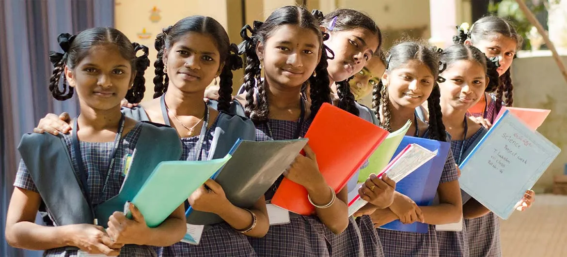 Schoolgirls holding their learning folders together